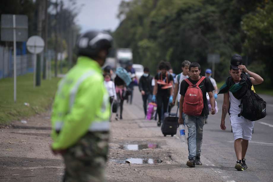 Migrantes venezolanos transitan por la autopista norte de Bogotá de regreso a Venezuela, en medio de la cuarentena obligatoria por cuenta del Covid-19.