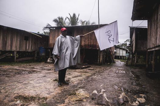 Un habitante del río San Juan sostiene una bandera blanca en medio de la misión humanitaria con acompañamiento de la iglesia, que recorrió la zona en octubre de 2021. / Santiago Ramírez.