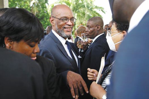 New Prime Minister Ariel Henry, center, talks to members of his cabinet after his appointment in Port-au-Prince, Haiti, Tuesday, July 20, 2021, weeks after the assassination of President Jovenel Moise at his home. (AP Photo/Joseph Odelyn)
