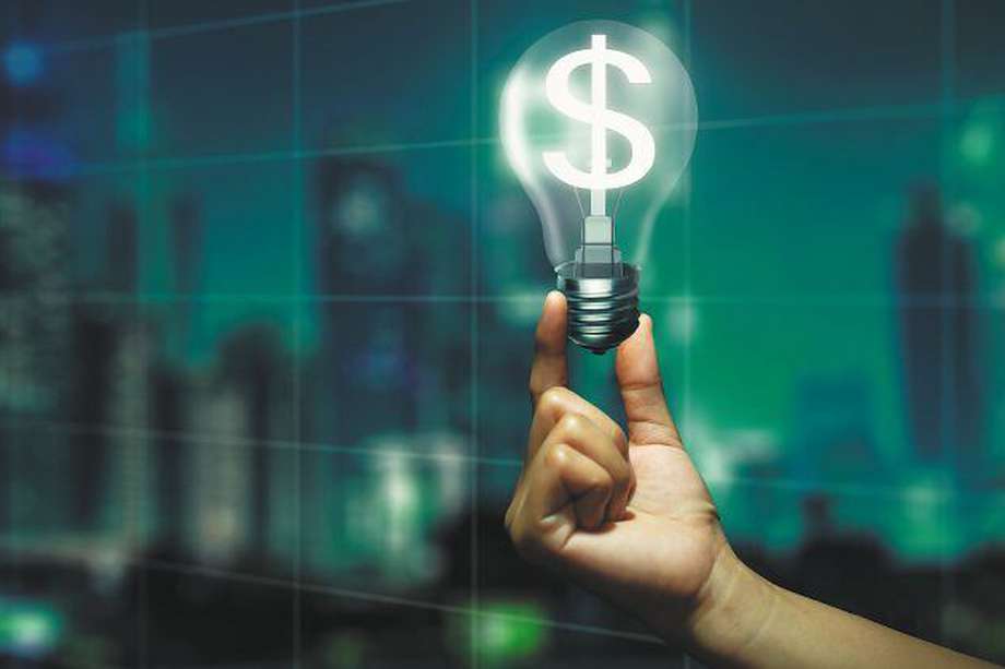 Double Exposure of Hand holding glowing light bulb with dollar sign inside and Night City background. Money making idea and Growth of dollar exchange rate Concept.