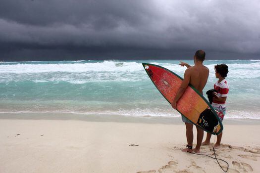 Turistas observan la llegada de la tormenta tropical "Karen" desde una playa del centro de recreo de Cancún, en el estado mexicano de Quintana Roo./ EFE