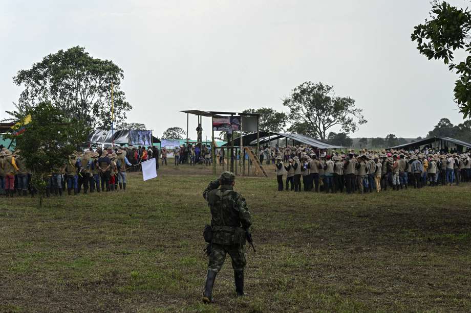 Un combatiente de la disidencia de las FARC EP camina como miembros de la Guardia Campesina durante una reunión con las comunidades locales en San Vicente del Caguán, a donde los comandantes guerrilleros anunciarán a sus negociadores de paz con el Gobierno. Joaquín Sarmiento / AFP