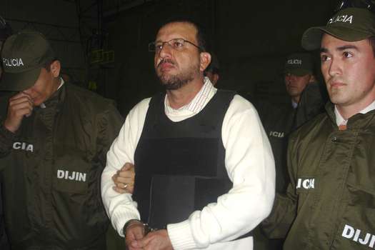 Colombian Carlos Mario Jimenez, known as "Macaco", is escorted by members of the Secret Police in Bogota, before being extradited May 7, 2008. Colombia extradited Jimenez to the United States on Wednesday, marking the first time the government has sent a former right-wing paramilitary boss to face U.S. justice for drug trafficking.  REUTERS/Dijin/Handout (COLOMBIA).  FOR EDITORIAL USE ONLY. NOT FOR SALE FOR MARKETING OR ADVERTISING CAMPAIGNS.