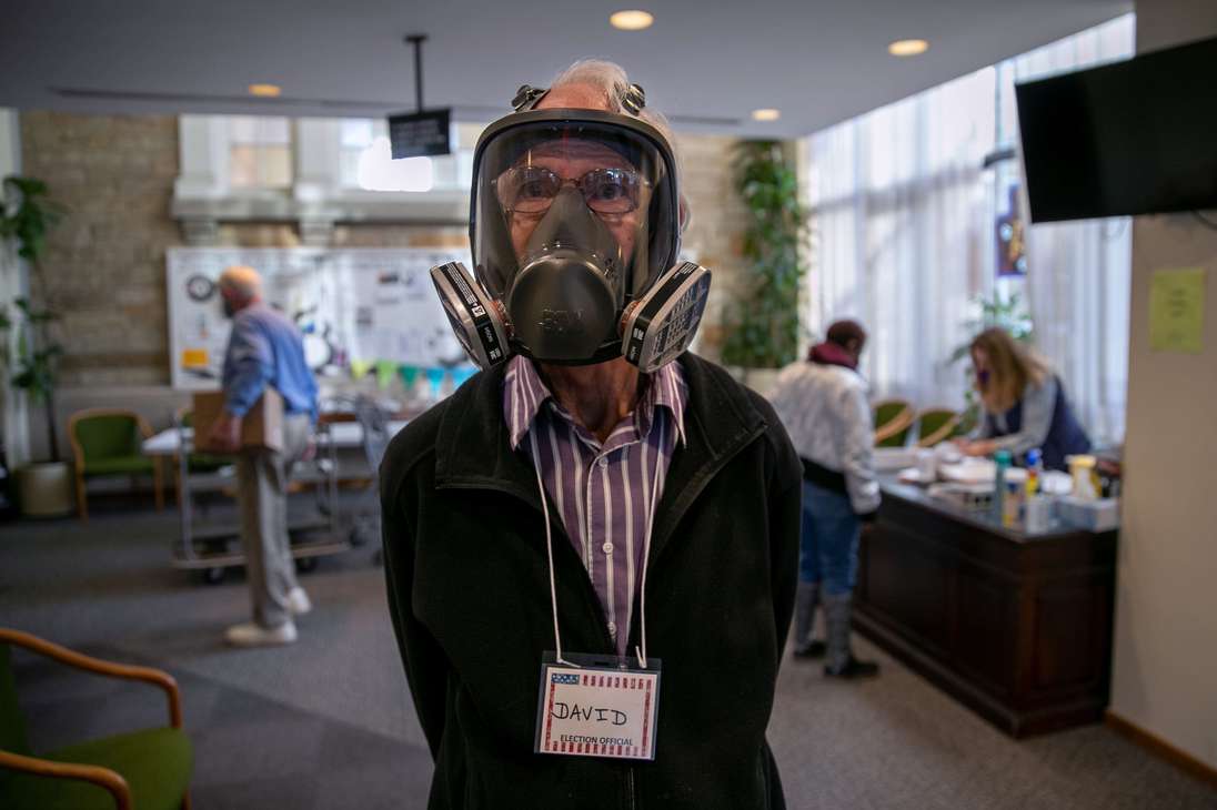 LANSING, MICHIGAN - NOVEMBER 03: Election inspector David Hopkinson wears a full-face ventilator as a protection against Covid-19 while working at the Emanuel First Lutheran School polling center on November 03, 2020 in Lansing, Michigan. After a record-breaking early voting turnout, Americans went to the polls on the last day to cast their vote for incumbent U.S. President Donald Trump or Democratic nominee Joe Biden in the 2020 presidential election.   John Moore/Getty Images/AFP