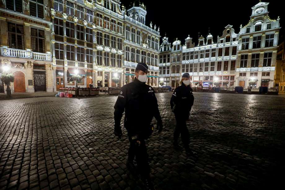 Agentes de policía con máscaras protectoras patrullan al inicio del toque de queda en Bruselas el 19 de octubre de 2020 como medida contra la propagación de la pandemia COVID-19 causada por el nuevo coronavirus.