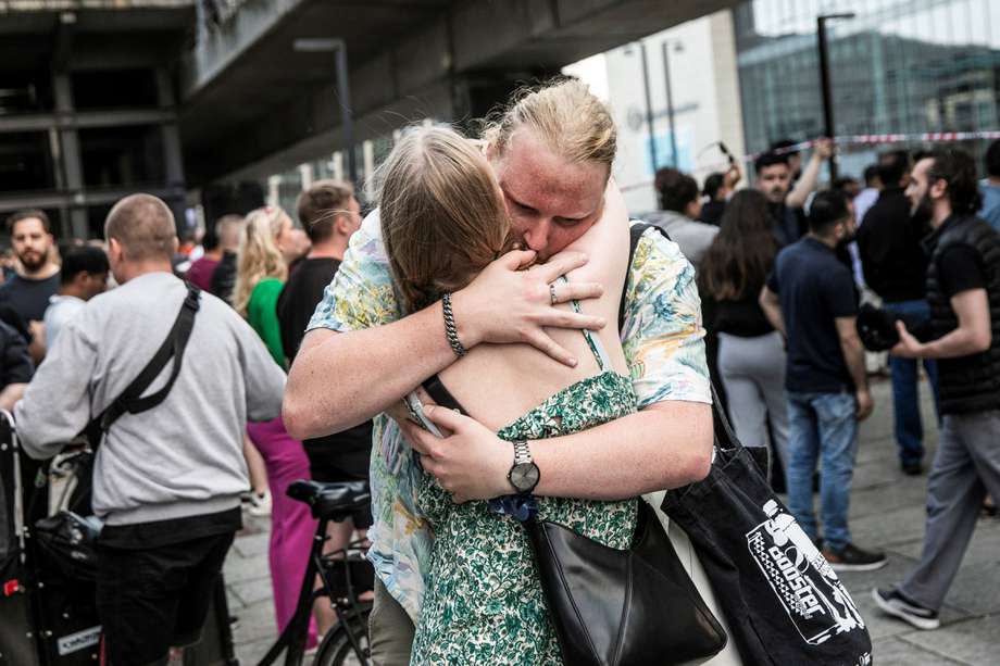 La gente se abraza frente al centro comercial Fields, donde un hombre armado mató a tres personas e hirió a varias más en Copenhague el 3 de julio de 2022.