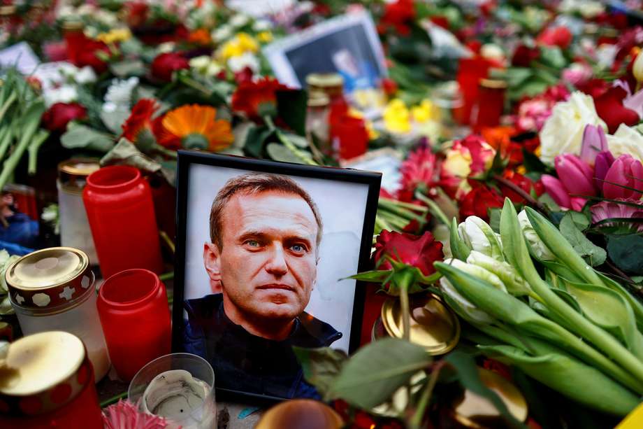 Una foto que muestra al fallecido líder de la oposición rusa Alexéi Navalni sentado entre tributos florales frente a la embajada rusa en Berlín, Alemania. El crítico del Kremlin murió en una colonia penal, anunció el 16 de febrero de 2024 el Servicio Penitenciario Federal del Distrito Autónomo de Yamalo-Nenets. 
