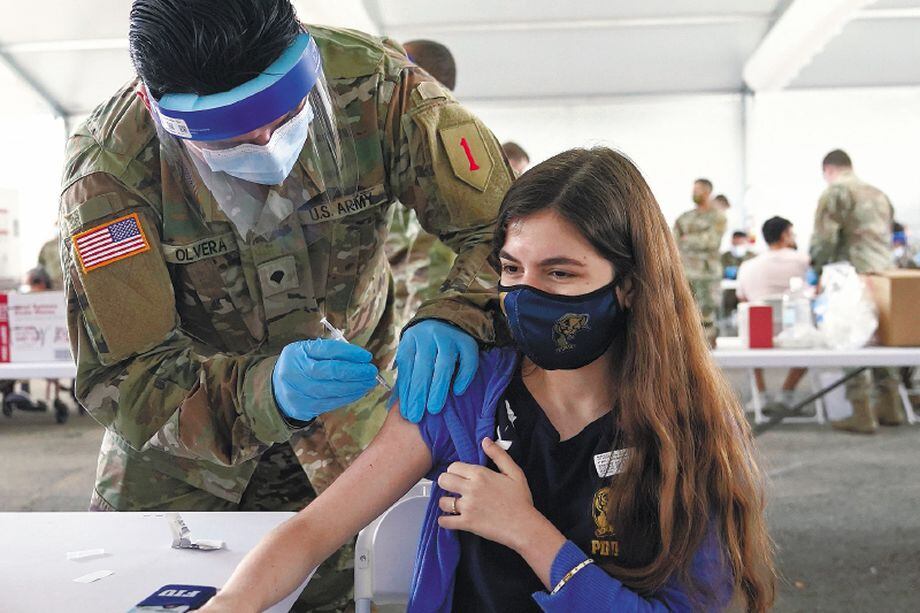 Natalie Ruiz,19, receives the Pfizer COVID-19 vaccine at a FEMA vaccination center at Miami Dade College, Monday, April 5, 2021, in Miami. Any adult in Florida is now eligible to receive the coronavirus vaccine. In addition, the state announced that teens ages 16 and 17 can also get the vaccine with parental permission. (AP Photo/Lynne Sladky)