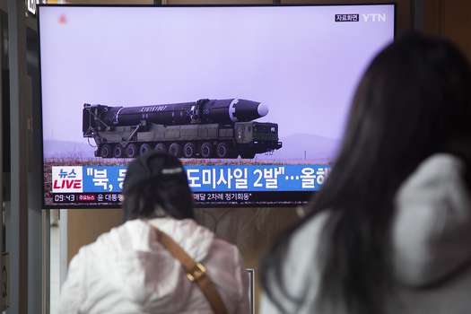 People watch the news of missile tests by North Korea on South Korean television.