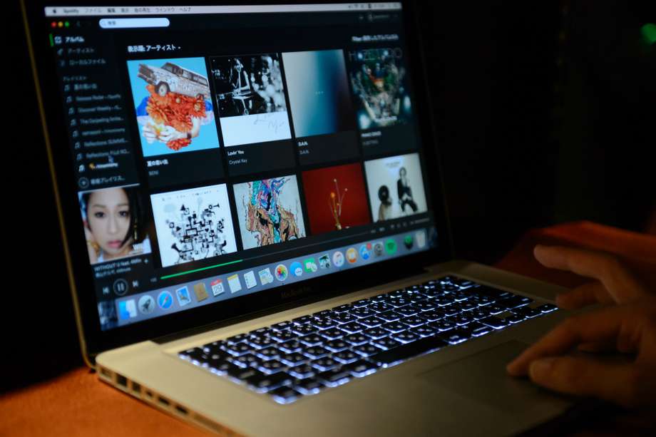 An attendee tries out Spotify Ltd.'s music streaming service, operated by Spotify Japan K.K., on a laptop computer during a launch event in Tokyo, Japan, on Thursday, Sept. 29, 2016. Spotify Ltd. is bringing its popular online music service to Japan, a large and lucrative market where fans have demonstrated a continuing fondness for CDs and even vinyl records. Photographer: Akio Kon/Bloomberg