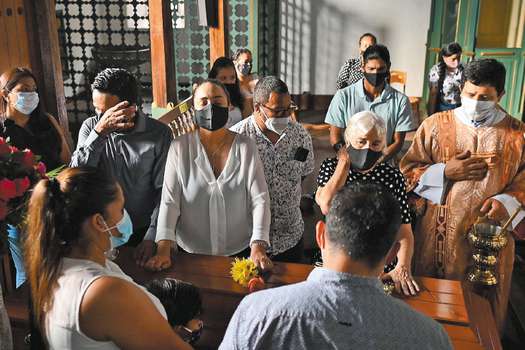 Relatives of Jacobo Perez, 18, one of the five young people killed by armed men on a farm in rural area of Buga, in the early morning of last Sunday, attend his funeral in Buga, Colombia, on January 25, 2021.  This is the sixth massacre so far this year in the country, authorities reported. Despite the agreement with the FARC, the country is still in the midst of a conflict that has confronted guerrillas, state agents, paramilitaries and drug traffickers against each other for almost six decades, with a toll of more than nine million victims, including the dead, the disappeared and the displaced. / AFP / Luis ROBAYO