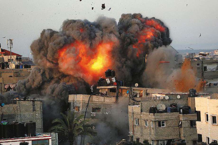A ball of fire erupts from a building in Gaza City's Rimal residential district on May 16, 2021, during massive Israeli bombardment on the Hamas-controlled enclave. (Photo by Bashar TALEB / AFP)