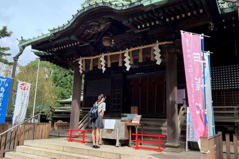 Una joven orando en el templo sintoista de Hachiman, en Tokio.