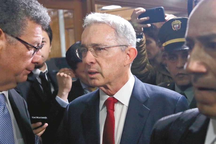 Former president Alvaro Uribe arrives to the Supreme Court for questioning in a case an involving witness tampering in Bogota, Colombia, Tuesday, Oct. 8, 2019. Uribe is under investigation over allegations he made false accusations and tried to influence members of a former paramilitary group in a case he had started by accusing leftist Senator Ivan Cepeda of plotting to falsely tie him to right-wing paramilitary groups. (AP Photo/Ivan Valencia)