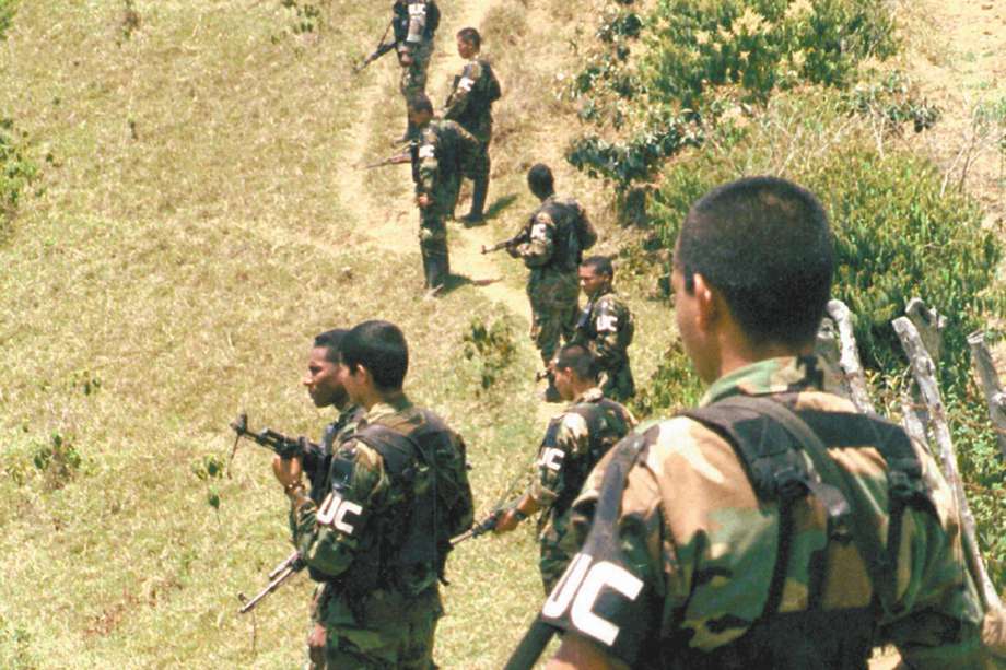 Members of the Calima front of the United Self-Defense Forces of Colombia, or AUC, stand on the hills during a military drill in the mountains of the southern state of Cauca, Tuesday, Aug. 13, 2002. The paramilitaries, which arose as a vigilante force to defend landowners against guerrilla kidnappings and extortion, have vastly increased their military strength over the past few years. They are blamed for most of the massacres committed in the country and last year the AUC was added by the U.S. State Department to its list of terrorist groups. Colombia's two main rebel groups are also on the list. (AP Photo/J. George)