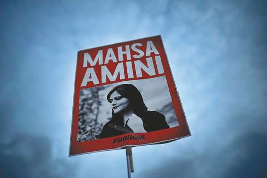 Una mujer sostiene una pancarta con una foto de la mujer iraní Mahsa Amini durante una protesta contra su muerte, en Berlín, Alemania, el miércoles 28 de septiembre de 2022.