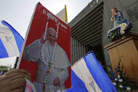 A faithful Nicaraguan Catholic holds an image of Pope Francis, during an outdoor mass, to demand an end to violence in his country, in front of the Metropolitan Cathedral of Managua.