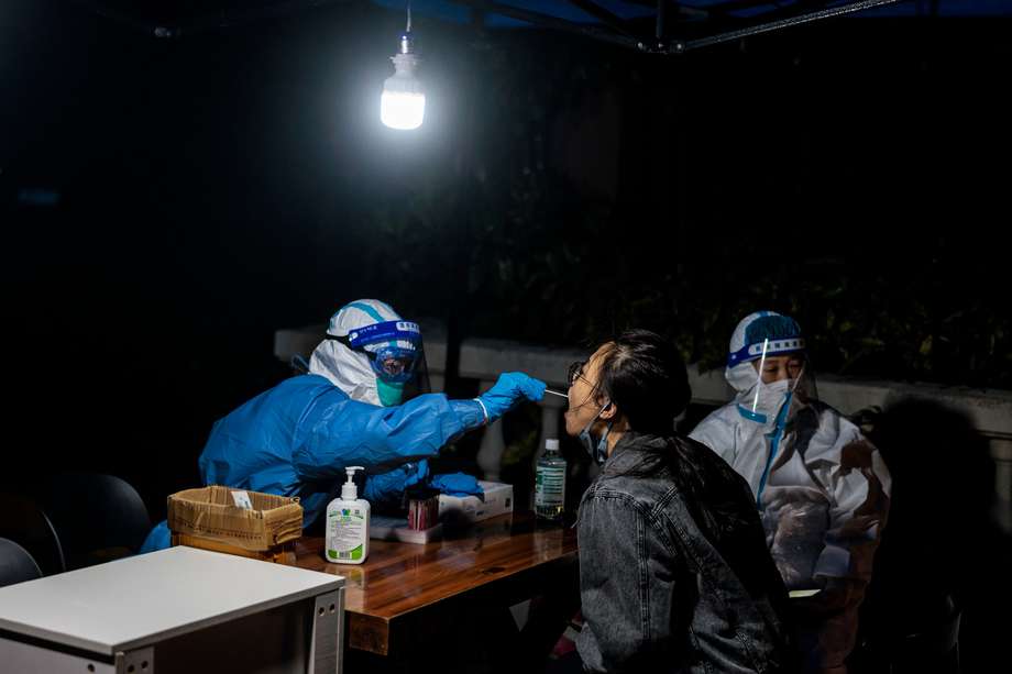 Una mujer se somete a la prueba de covid-19 en una comunidad residencial en cuarentena en Shanghái, China, el 9 de abril de 2022. Shanghái se encuentra actualmente bajo un estricto bloqueo de covid-19 y los residentes se quejan de la escasez de alimentos. EFE/EPA/ALEX PLAVEVSKI
