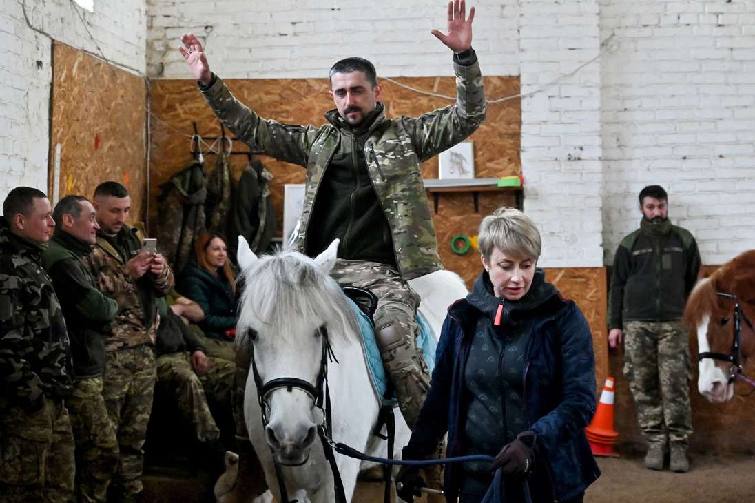 Un jinete en uniforme de camuflaje monta a Melocotón, uno de los caballos de un centro ecuestre de las afueras de Kiev donde los soldados ucranianos descansan de los horrores de la guerra.