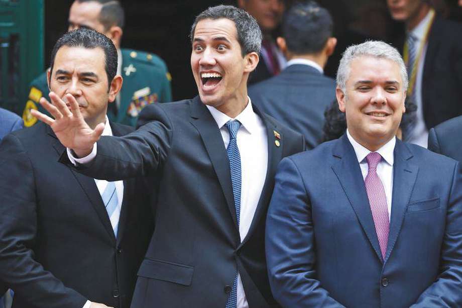 Venezuela's self-proclaimed interim president Juan Guaido waves alongside, from left, Guatemala's President Jimmy Morales, Colombia's President Ivan Duque and Panama's President Juan Carlos Varela as they gather for a group photo after attending an emergency Lima Group meeting concerning Venezuela, in Bogota, Colombia, Monday, Feb. 25, 2019.  As it struggles to find new ways to boost Guaido after an effort to deliver humanitarian aid to the economically devastated nation faltered amid strong resistance from security forces who remain loyal to Venezuela's President Nicolas Maduro, the Trump administration announced new sanctions on Maduro's allies. (AP Photo/Martin Mejia)