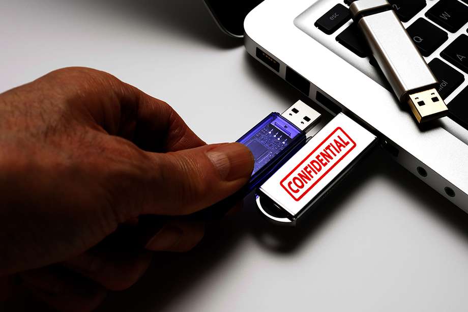 Connecting a confidential USB flash drive with laptop, isolated on white background.