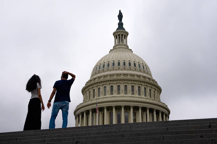 People walk past the US Capitol in Washington, DC.