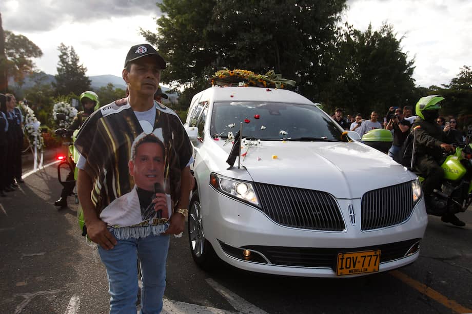 Seguidores del cantante colombiano Darío Gómez acompañan la caravana con el cortejo fúnebre que lleva el cuerpo del artista rumbo a su entierro en el cementerio Campos de Paz, ayer, en Medellín (Colombia). EFE/ Luis Eduardo Noriega