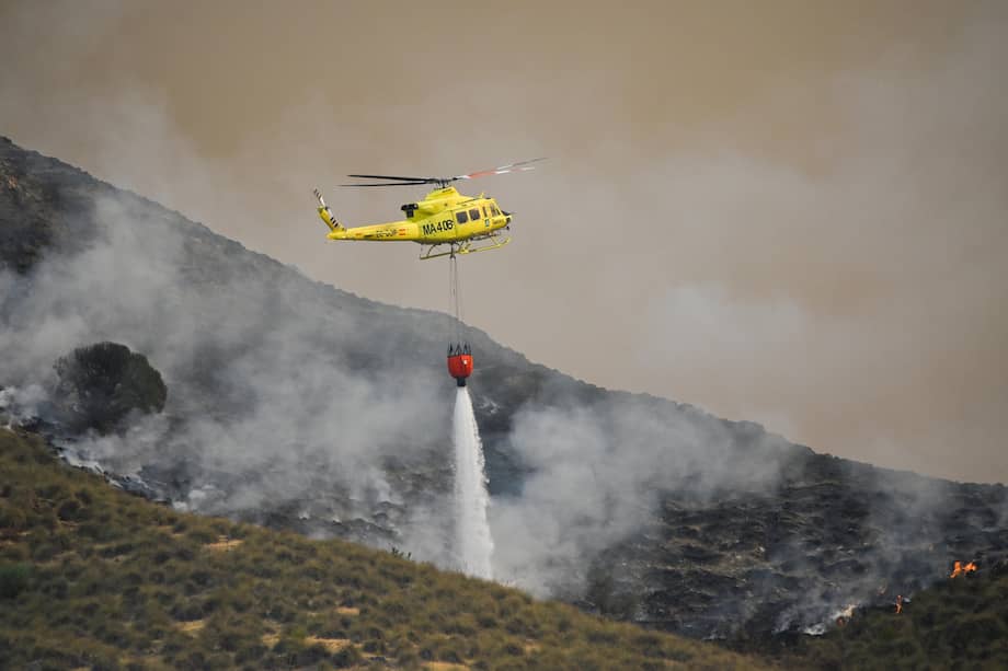 Un helicóptero del servicio de extinción de incendios arroja agua sobre uno de los focos del incendio forestal declarado en Los Gallardos, Almería.