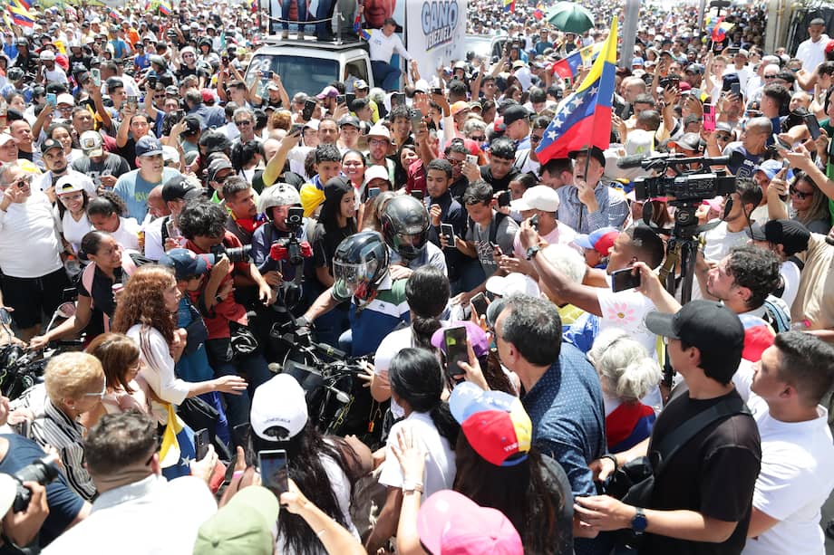 La líder opositora de Venezuela María Corina Machado (atrás) se retira en moto tras asistir a una protesta en rechazo a los resultados oficiales de las elecciones presidenciales -que dan la victoria al presidente Nicolás Maduro- en la Plaza de las Mercedes, este sábado en Caracas (Venezuela).