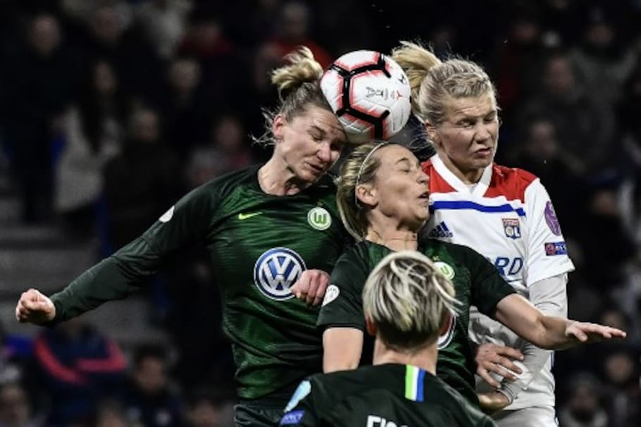 Lyon's Norwegian forward Ada Hegerberg (R) heads the ball with Wolfsburg's German midfielder Lena Goessling (C) and Wolfsburg's German forward Alexandra Popp (L) during the UEFA women's Champions League quarter-final football match between Olympique Lyonnais and Vfl Wolfsburg at the Groupama Stadium in Decines-Charpieu, near Lyon, central-eastern France on March 20, 2019. (Photo by JEFF PACHOUD / AFP)