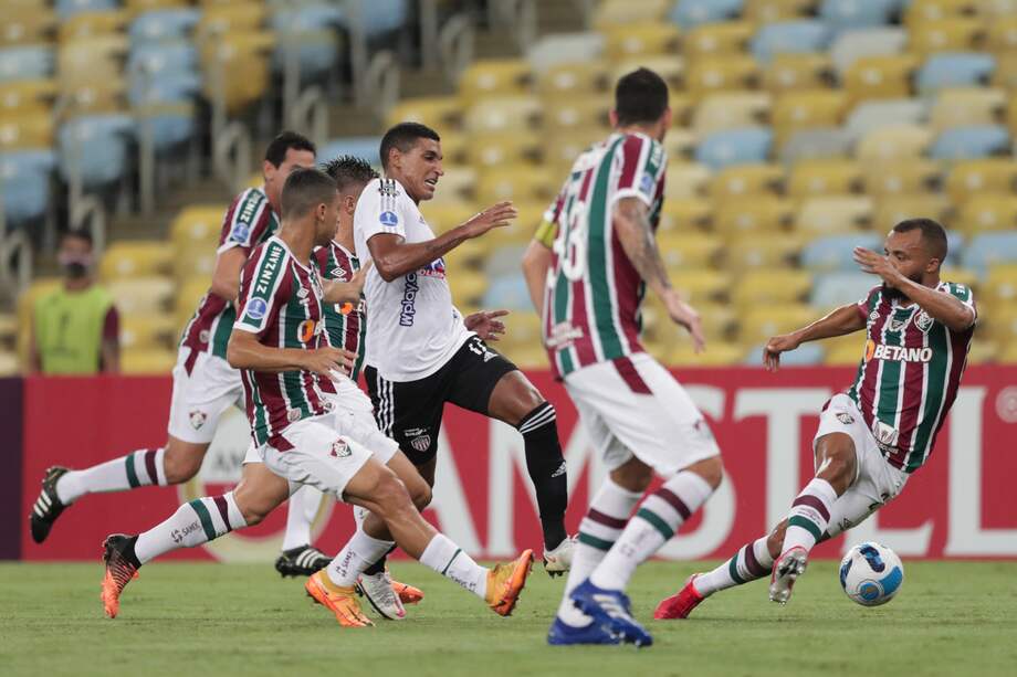 Gabriel Fuentes (c) avanza con la pelota este miércoles en el partido contra Fluminense.