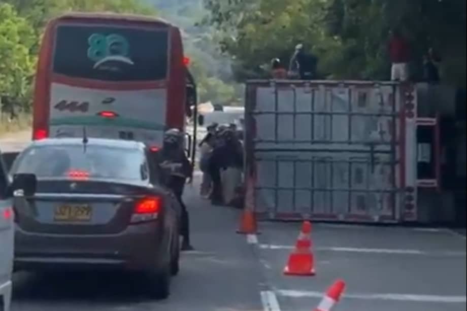 Pasajeros de un bus se bajaron y se llevaron parte de la mercancía del camión volcado.