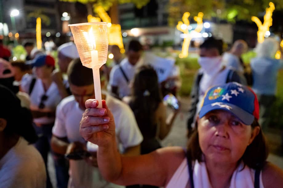 Una mujer sostiene una vela durante una vigilia en Caracas (Venezuela) por los presos político.