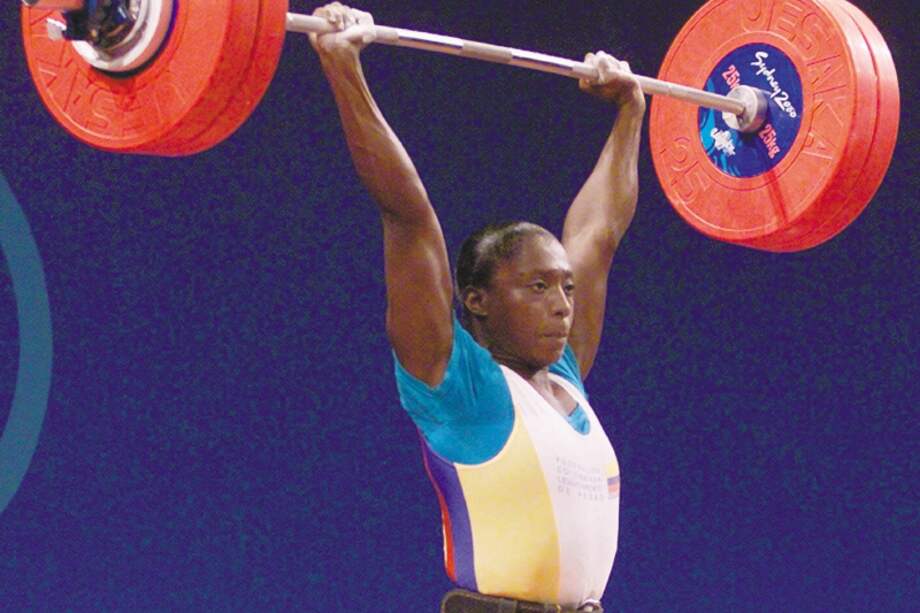 Colombia's Maria Isabel Urrutia finishes a lift in the clean and jerk event to win the gold medal in the women's 75 kg weightlifting event at the Summer Olympic Games in Sydney Australia Wednesday Sept. 20, 2000. (AP Photo/David Guttenfelder)