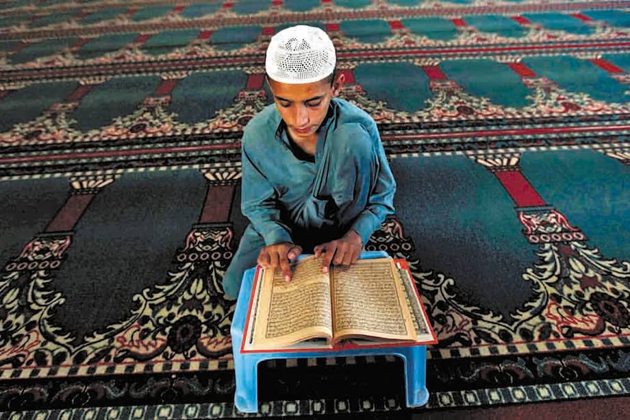 Un joven paquistaní lee el Corán en una mezquita de Peshawar (Pakistán) durante el Ramadán. / EFE