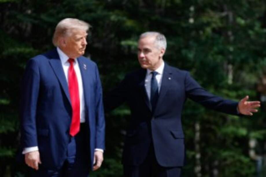 (FILES) (L/R) US President Donald Trump and Canadian Prime Minister Mark Carney take part in an arrival ceremony during the Group of Seven (G7) Summit at the Pomeroy Kananaskis Mountain Lodge in Kananaskis, Alberta, Canada on June 16, 2025. The White House said on June 30, 2025, that Canadian Prime Minister Mark Carney had "caved" to President Donald Trump, after Canada dropped a tax on US tech firms that prompted Trump to call off trade talks. (Photo by Ludovic MARIN / POOL / AFP)