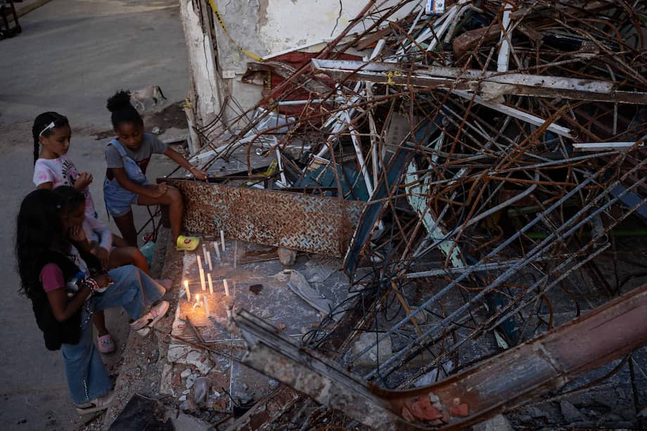 Personas encienden velas durante un homenaje a las victimas por los terremotos del pasado 24 de junio, este viernes en Catia La Mar (Venezuela).