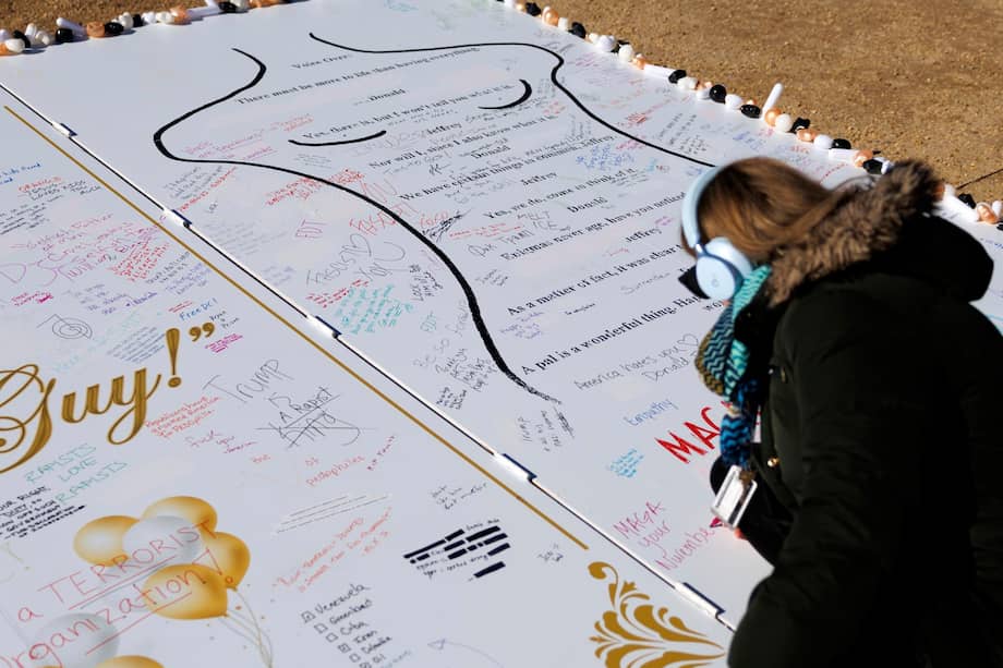 Una persona se encuentra frente a una instalación de arte que representa un mensaje de cumpleaños de Epstein supuestamente escrito por el presidente de Estados Unidos, Donald Trump.