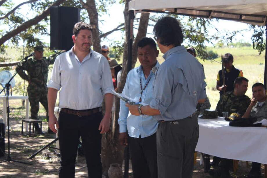 El viceministro de Agricultura, Javier Pérez, (izquierda) junto con el director de la Unidad de Restitución de Tierras, Andrés Augusto Castro Forero, entregando la sentencia al gobernador de la comunidad de Kanalitojo. / Juan Sebastián Lombo Delgado-El Espectador
