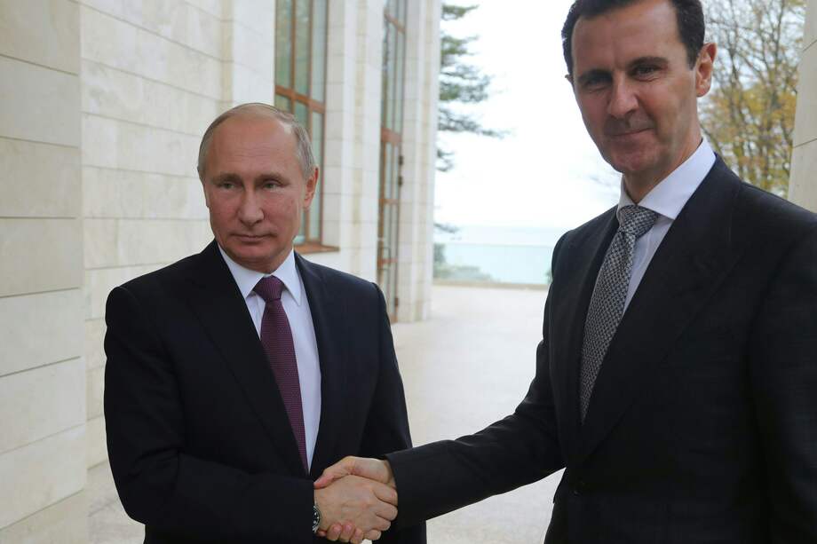 Vladimir Putin (izq) y Basher al-Asad (der). / AFP