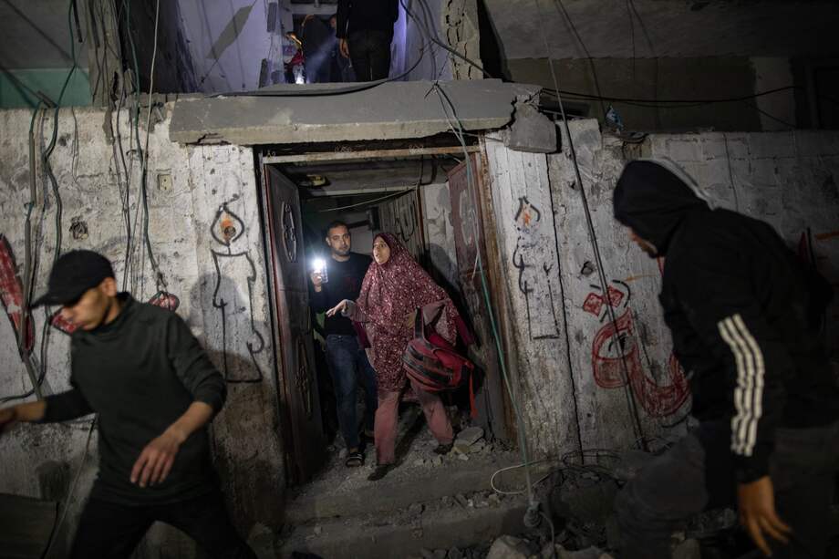 Palestinos buscan cadáveres y supervivientes bajo los escombros del edificio residencial de la familia Zatma, destruido por un ataque aéreo israelí en el campo de refugiados de Rafah, en el sur de la Franja de Gaza, 26 de febrero de 2024.