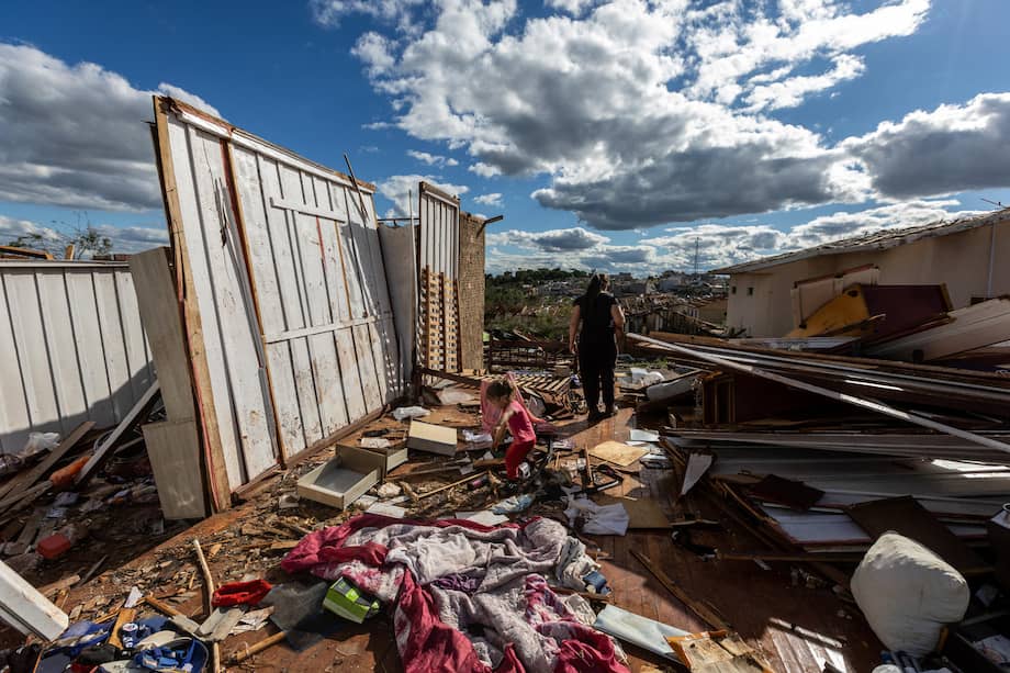 Personas caminan en medio de los escombros causados por un tornado en Río Bonito de Iguaçu (Brasil).