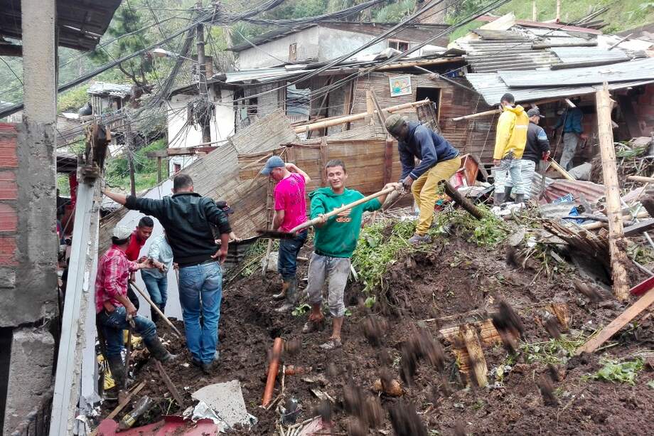 Los vecinos de las zonas afectadas ayudan en la remoción de escombros. / AFP
