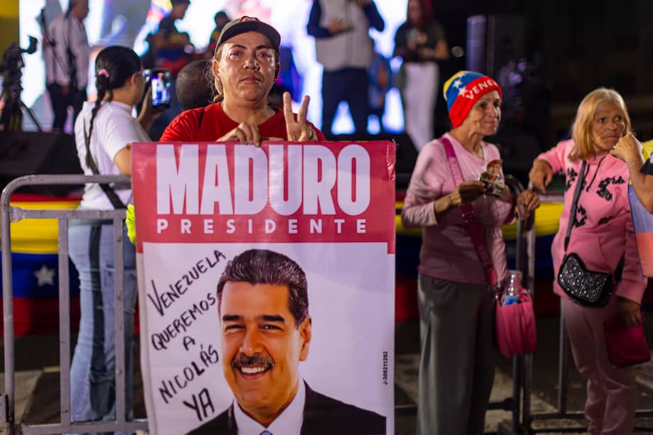 Una persona sostiene un cartel con la imagen del mandatario venezolano, Nicolás Maduro, durante en una vigilia, en Caracas (Venezuela).