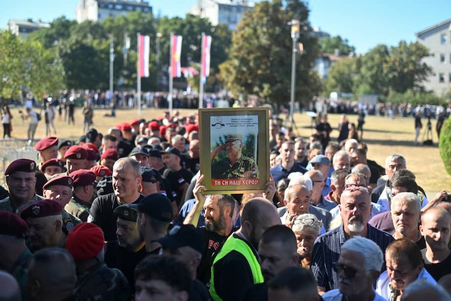 Dolientes, sosteniendo un retrato del difunto líder militar serbobosnio Ratko Mladic.