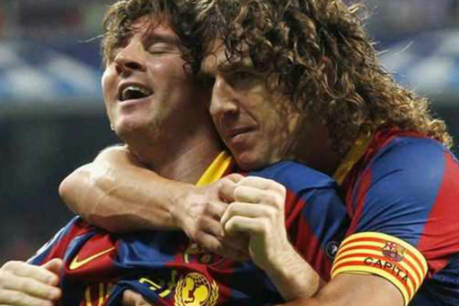 Lionel Messi y Carles Puyol cuando compartían plantel en el Barcelona. / AFP
