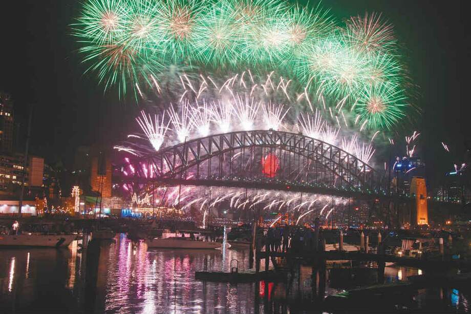 A la medianoche del 31 de diciembre, un espectacular ‘show’ de juegos pirotécnicos ilumina el Puente del Puerto de Sídney, Australia. / 123rf