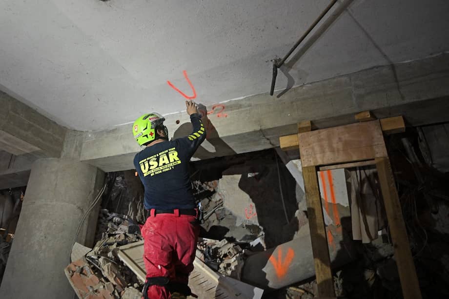 Un rescatista estadounidense marca con la letra "V" (de víctimas) una pared en el garaje del edificio de donde fue rescatado Hernán Gil, en Catia La Mar, La Guaira (Venezuela).