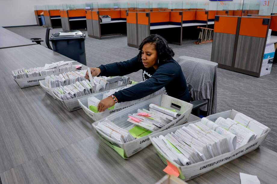 Un trabajador clasifica los formularios de inscripción de votantes en Georgia.