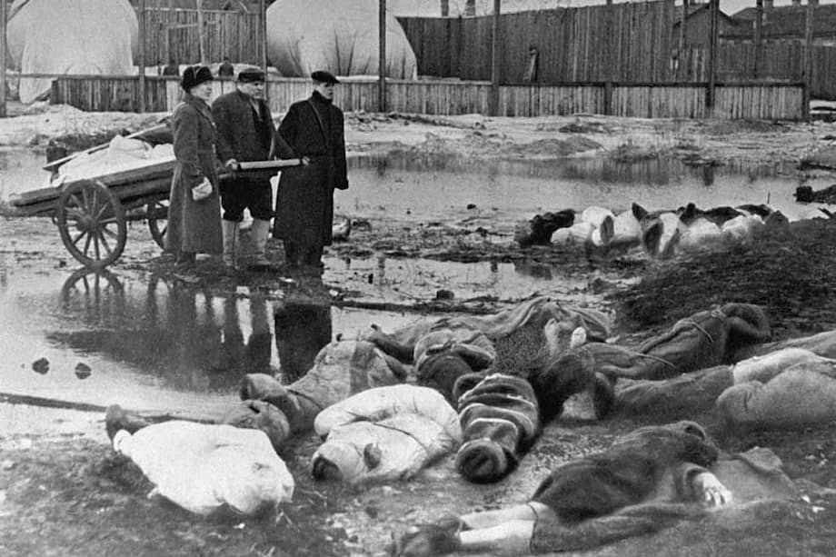 Tres hombres buscan entre las víctimas de la guerra en el cementerio Volkovo, en Leningrado. / RIA Novosti